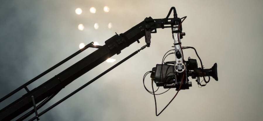 Camera suspended above sports field in front of floodlights Camera suspended above sports field in front of floodlights