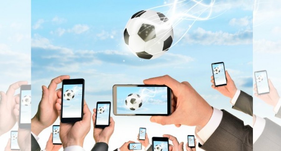 Hands_holding_phones_recording_a_Football_falling Hands_holding_phones_recording_a_Football_falling