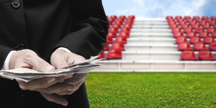 Man holding money on sports field Man holding money on sports field