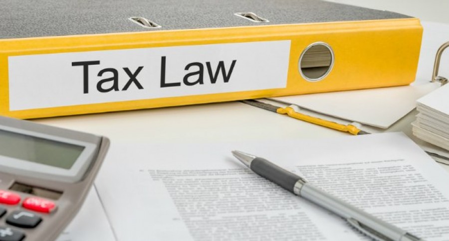 Tax_Law_on_Yellow_folder_with_paperwork Tax_Law_on_Yellow_folder_with_paperwork