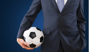Man in suit holding Football