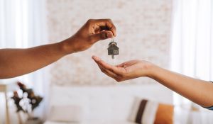 Agent handing keys to tenant