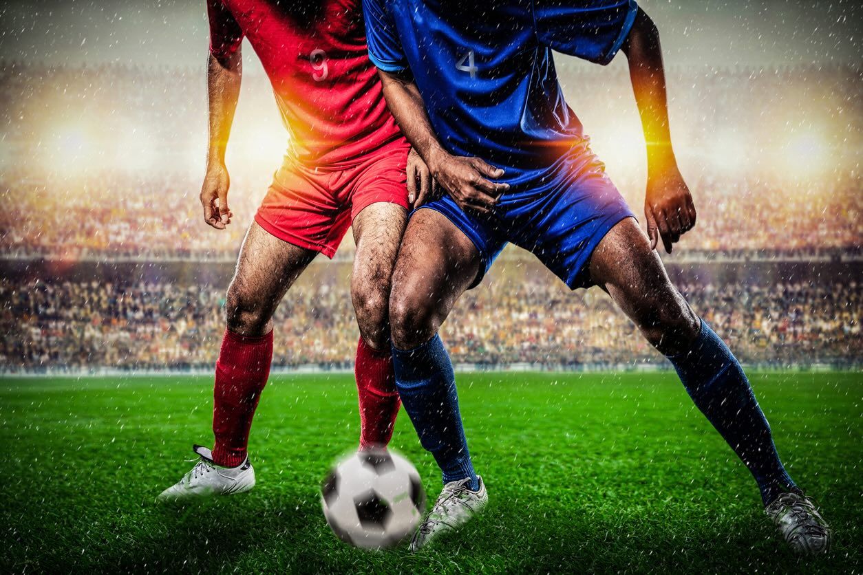 Two Footballers Tackling
