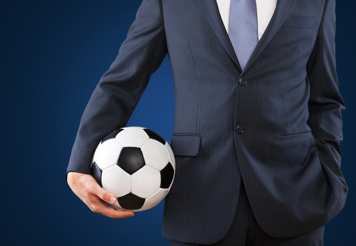 Man in suit holding Football