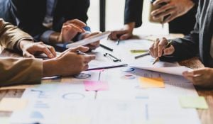 People brainstorming around table with papers