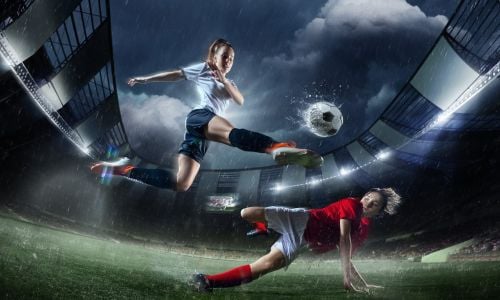 Female Footballer Tackling