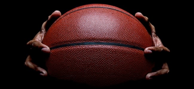 Hands holding basketball 