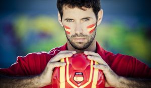 Man holding football with a Spanish flag