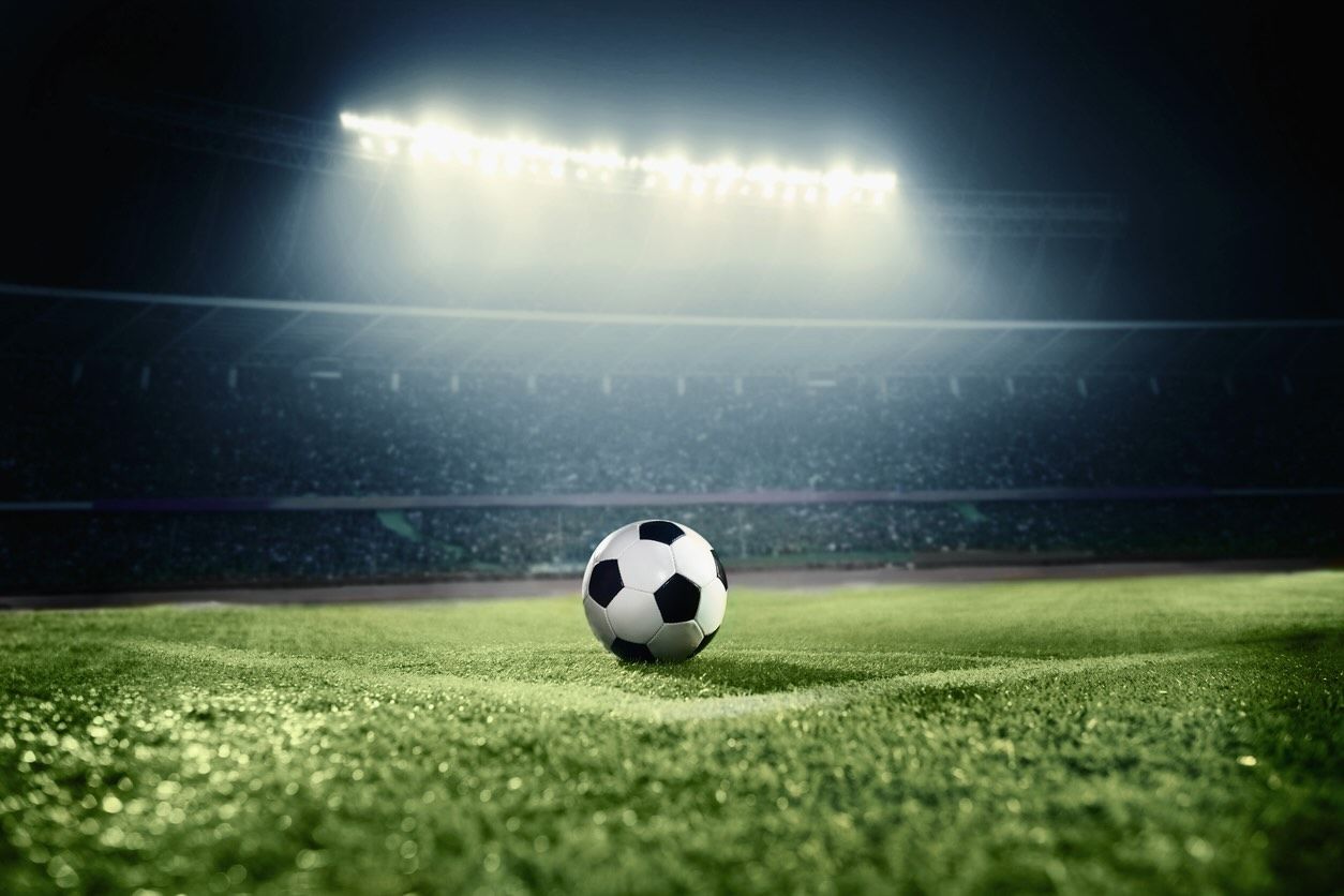 Title image of soccer ball on athletic field in stadium arena