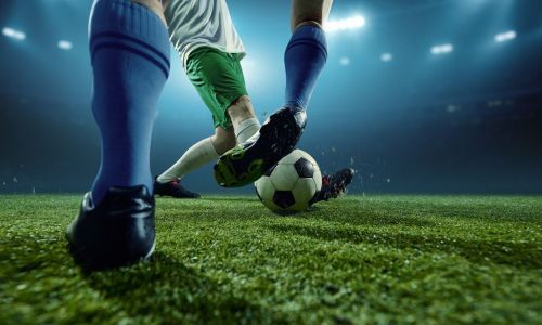 Title image of Footballers challenging for ball