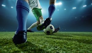 Title image of Footballers challenging for ball