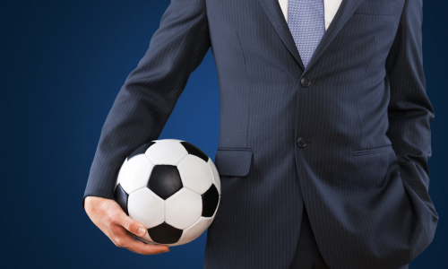 Man in suit holding Football