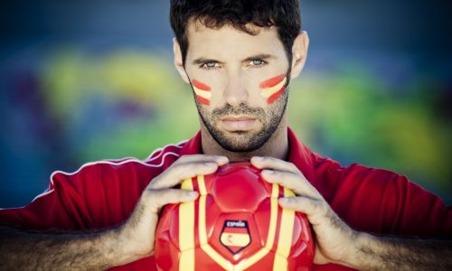 Man holding football with a Spanish flag