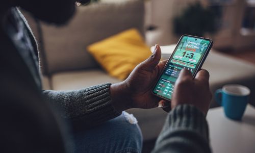 Man using live sports betting application on his phone
