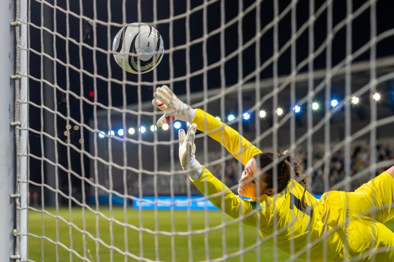 Women goalkeeper saving shot